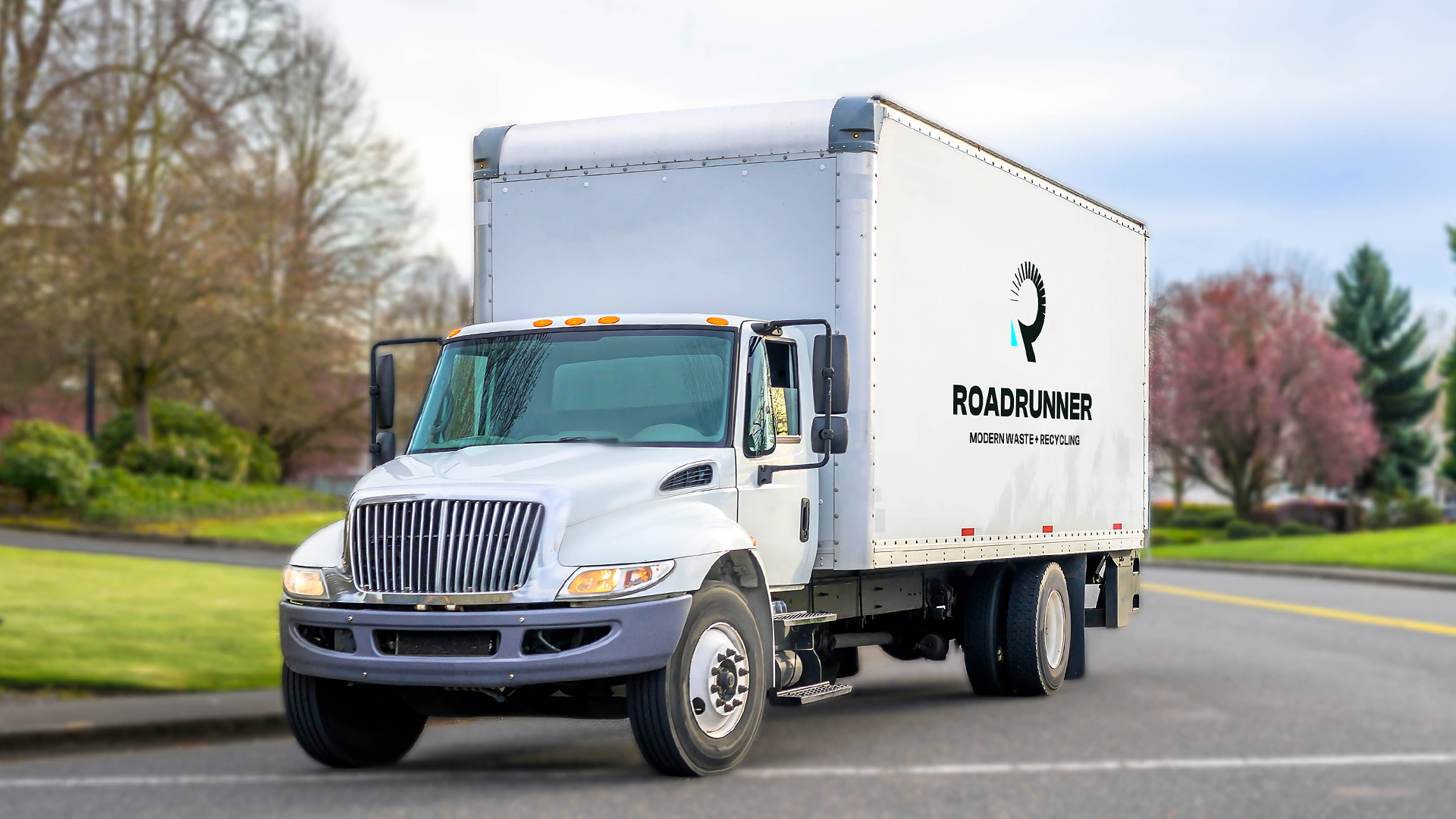 a white box truck driving on a road